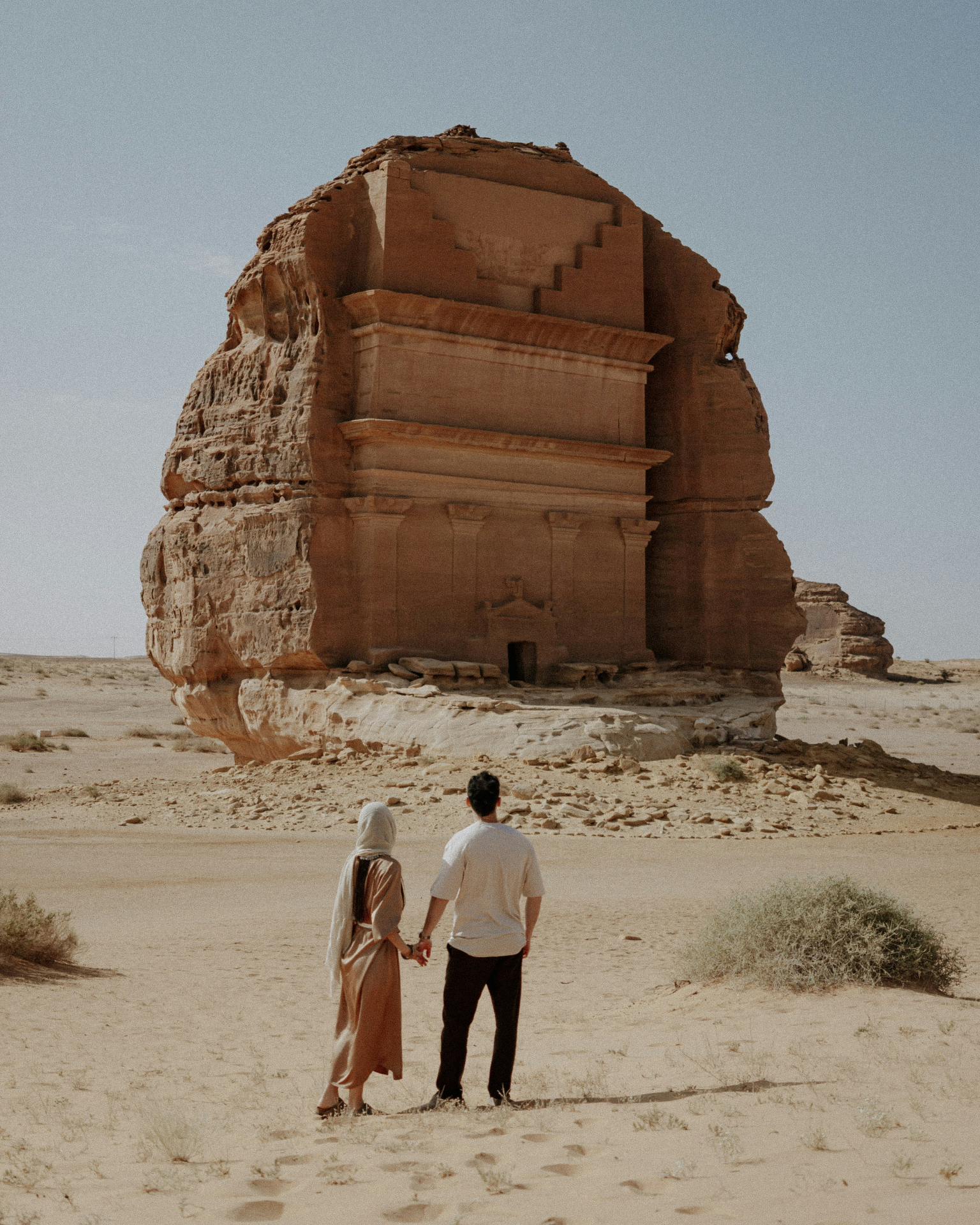 Couple in desert at Hegra, Saudi Arabia